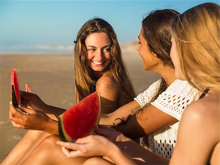 pictures of people eating watermelon on the beach - Best friends having fun on the beach and eating watermelon Stock Photo - Budget Royalty-Free & Subscription, Code: 400-09010315