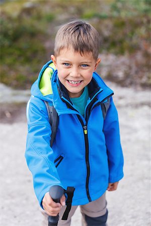 simsearch:400-08713043,k - Happy hiking boy with trekking sticks in the mountains. Norway Fotografie stock - Microstock e Abbonamento, Codice: 400-09010338