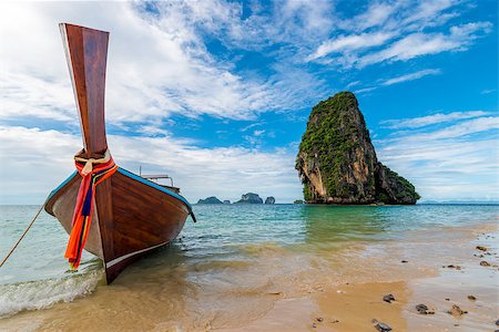 simsearch:400-07295709,k - A wooden Thai boat with a motor on the background of a high cliff in the Andaman Sea Stock Photo - Budget Royalty-Free & Subscription, Code: 400-09010465