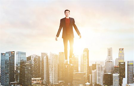 Businessman hovering over down town on sunset. Stock Photo - Budget Royalty-Free & Subscription, Code: 400-09010586