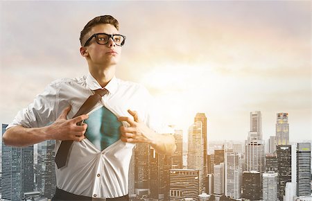 Business superhero. Young businessman showing super hero suit under his shirt down town on sunset. Stock Photo - Budget Royalty-Free & Subscription, Code: 400-09010587