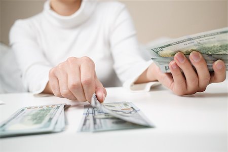 Close up of woman with calculator counting money Stock Photo - Budget Royalty-Free & Subscription, Code: 400-09010594