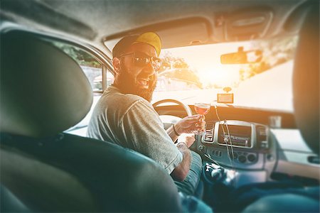 simsearch:400-08433799,k - funny smiling bearded man with glass of wine in the car on the driver place Stock Photo - Budget Royalty-Free & Subscription, Code: 400-09010904