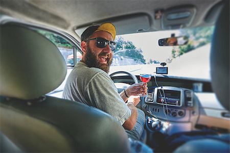 simsearch:400-08433799,k - funny smiling bearded man with glass of wine in the car on the driver place Stock Photo - Budget Royalty-Free & Subscription, Code: 400-09010903