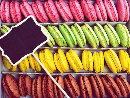 Multicolored biscuits macaroons in a paper box, top is a wooden blank pointer Stockbilder - Microstock & Abonnement, Bildnummer: 400-09011202