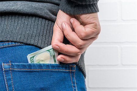 simsearch:400-06102745,k - A man's hand pulls out dollars from the back pocket of jeans Photographie de stock - Aubaine LD & Abonnement, Code: 400-09011294