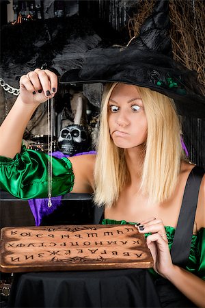 simsearch:400-07776243,k - perplexed fortune teller with a crystal and a board with letters Fotografie stock - Microstock e Abbonamento, Codice: 400-09011627