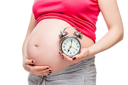 simsearch:400-04396054,k - big pregnant belly and alarm clock closeup isolated on white background Photographie de stock - Aubaine LD & Abonnement, Code: 400-09011631