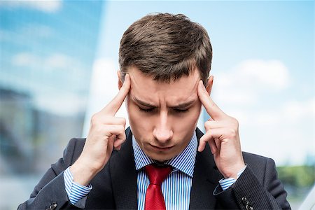 simsearch:400-04345508,k - Portrait of a businessman with a strong headache and troubles in business in office Stock Photo - Budget Royalty-Free & Subscription, Code: 400-09011720