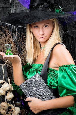 simsearch:400-07776243,k - vertical portrait of a beautiful witch with a magic book in his hands Fotografie stock - Microstock e Abbonamento, Codice: 400-09011722