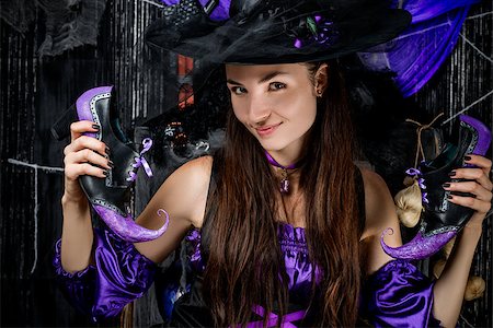 simsearch:400-07776243,k - Beautiful brunette witch with shoes on a black background Fotografie stock - Microstock e Abbonamento, Codice: 400-09011723