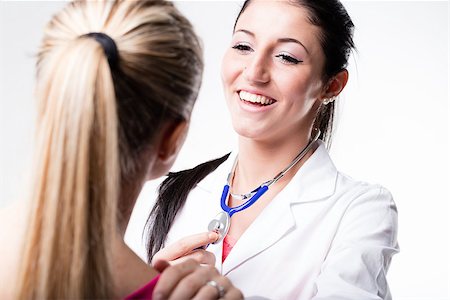 simsearch:400-09028278,k - doctor talking and laughing with her patient, they are in front of each other and this medical examination seems to have been gone very well Fotografie stock - Microstock e Abbonamento, Codice: 400-09028279