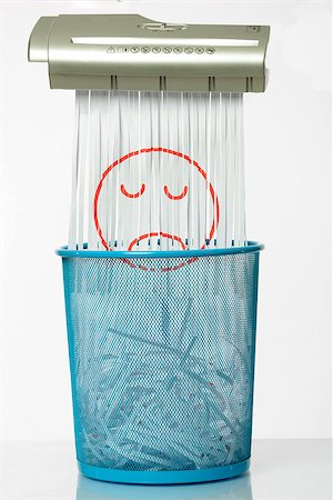 simsearch:400-04292189,k - Destroy the sadness. Shredder documents with printed images concept thrown in the trash. White and blue basket. Fotografie stock - Microstock e Abbonamento, Codice: 400-09028315