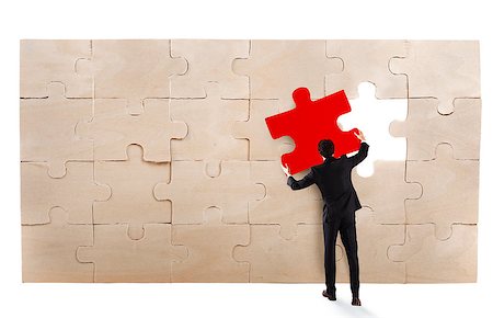 simsearch:400-08668633,k - Businessman complete a puzzle inserting a missing piece Stock Photo - Budget Royalty-Free & Subscription, Code: 400-09028333