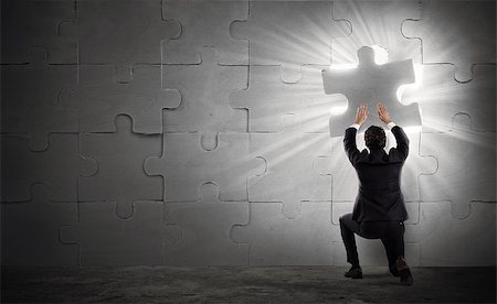 simsearch:400-08669915,k - Businessman complete a puzzle inserting a missing piece Stock Photo - Budget Royalty-Free & Subscription, Code: 400-09028682