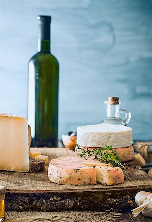 plate of cold cuts and cheeses - Cheese on wood. Types of cheese and herbs on wood Stock Photo - Budget Royalty-Free & Subscription, Code: 400-09028811