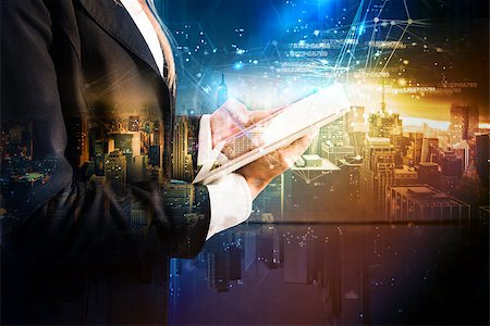 simsearch:400-09029842,k - Businessman with tablet on futuristic background with city. The technology that develops in the future Photographie de stock - Aubaine LD & Abonnement, Code: 400-09029163