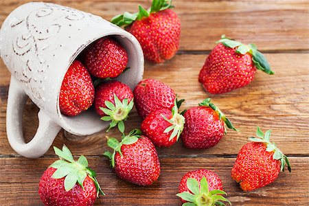 simsearch:400-08672192,k - Fresh ripe strawberries in mug, wooden background Photographie de stock - Aubaine LD & Abonnement, Code: 400-09029384