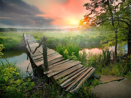 Old wooden bridge through narrow river at sunrise Stock Photo - Budget Royalty-Free & Subscription, Code: 400-09029616