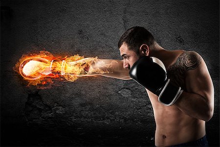 simsearch:400-07036748,k - Determined and confident boxer with fiery boxing gloves Foto de stock - Royalty-Free Super Valor e Assinatura, Número: 400-09029642