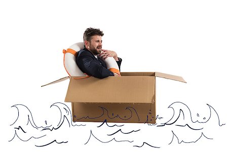 Afraid businessman with cardboard and lifebelt in the ocean Stock Photo - Budget Royalty-Free & Subscription, Code: 400-09029838