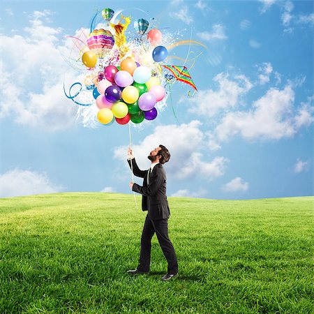 Creative businessman holding a creative colorful balloons Stock Photo - Budget Royalty-Free & Subscription, Code: 400-09029843