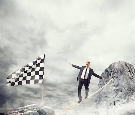 simsearch:632-05603965,k - Business concept of businessman who overcome the problems reaching the finish line on a rope Fotografie stock - Microstock e Abbonamento, Codice: 400-09030162