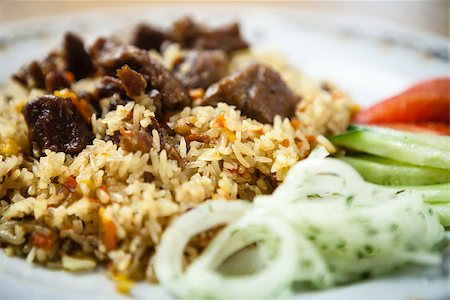 Uzbek pilaf with beef on a wooden background Stock Photo - Budget Royalty-Free & Subscription, Code: 400-09030348