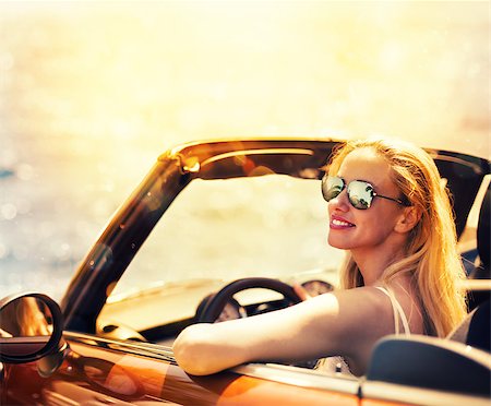 Young Caucasian woman in cabriolet car near sea Stock Photo - Budget Royalty-Free & Subscription, Code: 400-09030587