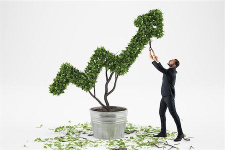 simsearch:400-08668627,k - Businessman cares for a big plant shaped as a big arrow Stock Photo - Budget Royalty-Free & Subscription, Code: 400-09030582