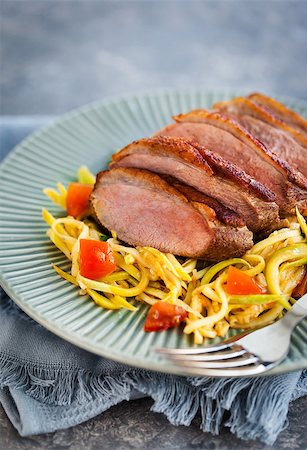 Roasted duck breast and zucchini noodles with tomatoes, healthy eating Stock Photo - Budget Royalty-Free & Subscription, Code: 400-09030610