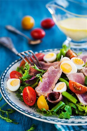 salad nicoise - Tuna salad ( Nicoise) with tomatoes, boiled eggs, onion, anchovy and lettuce Stock Photo - Budget Royalty-Free & Subscription, Code: 400-09030611