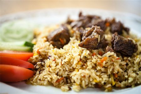 Uzbek pilaf with beef on a wooden background Stock Photo - Budget Royalty-Free & Subscription, Code: 400-09030850