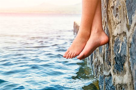 dock on a lake summer feet - Wet bare girl's feet dangling from the stone jetty Stock Photo - Budget Royalty-Free & Subscription, Code: 400-09030872