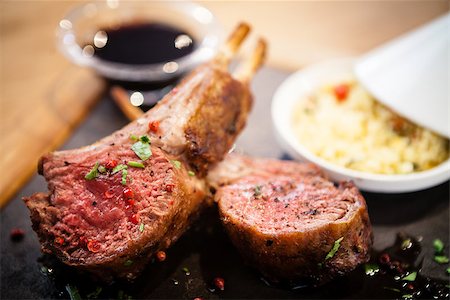 simsearch:400-05671438,k - Rack of New Zealand lamb. Served with couscous and pomegranate sauce. Foto de stock - Super Valor sin royalties y Suscripción, Código: 400-09030989