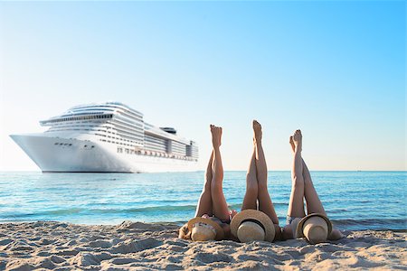 Group of happy friends having fun at ocean beach at dawn with legs up Stock Photo - Budget Royalty-Free & Subscription, Code: 400-09031149