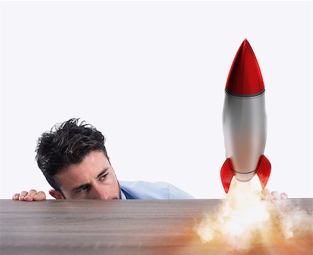 simsearch:400-08575298,k - Businessman holding a small rocket. Startup of a new company concept Stock Photo - Budget Royalty-Free & Subscription, Code: 400-09031163