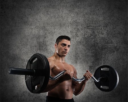 simsearch:400-08505882,k - Athletic muscular man training biceps in a grunge gym Stock Photo - Budget Royalty-Free & Subscription, Code: 400-09031979