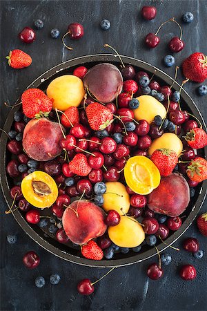 rustic tray - Fresh ripe summer berries and fruits (peaches, apricots, cherries and strawberries) on tray Stock Photo - Budget Royalty-Free & Subscription, Code: 400-09032016