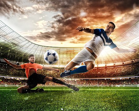 simsearch:400-08372849,k - Football action scene with competing football players at the stadium Stock Photo - Budget Royalty-Free & Subscription, Code: 400-09032081
