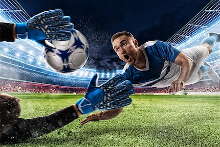 simsearch:400-09032117,k - Goalkeeper catches the ball in the stadium during a football game Foto de stock - Super Valor sin royalties y Suscripción, Código: 400-09032134