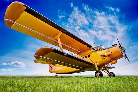 historic biplane against a cloudy sky Stock Photo - Budget Royalty-Free & Subscription, Code: 400-09032381