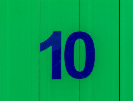 the number ten blue, set against bright green wood Stockbilder - Microstock & Abonnement, Bildnummer: 400-09045618