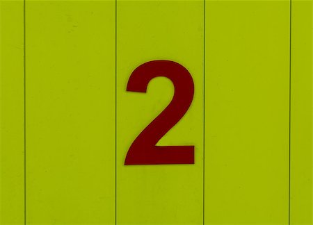 the number two, red, set against bright yellow wood Stockbilder - Microstock & Abonnement, Bildnummer: 400-09045619