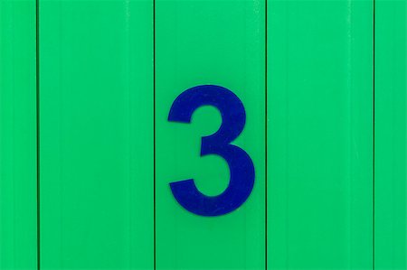 the number three, blue, set against bright green wood Stock Photo - Budget Royalty-Free & Subscription, Code: 400-09045620