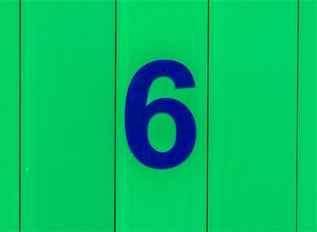 the number six, blue, set against bright green wood Stock Photo - Budget Royalty-Free & Subscription, Code: 400-09045623