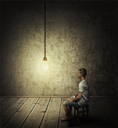 simsearch:400-07976631,k - Creative idea concept with a man sitting in a dark room, looking at a lightbulb Foto de stock - Royalty-Free Super Valor e Assinatura, Número: 400-09045765