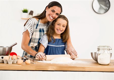 Shot of a mother and daughter having fun in the kitchen and learning to make a cake Stock Photo - Budget Royalty-Free & Subscription, Code: 400-09045811