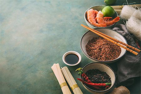Different types of rice and dried asian noodles and spices. Ingredients for cooking Asian dishes. Food background with copy space Stock Photo - Budget Royalty-Free & Subscription, Code: 400-09064023
