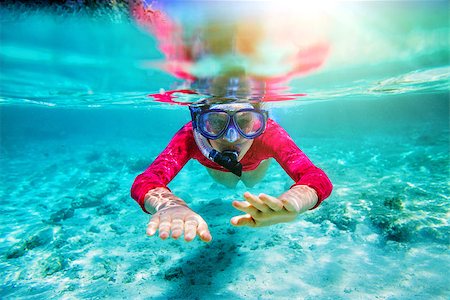 Girl swimming underwater in clear tropical waters Stock Photo - Budget Royalty-Free & Subscription, Code: 400-09064242